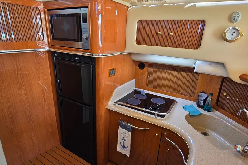 Slide: The Image of Luxurious kitchen interior of 2000 Sea Ray 400 Sedan Bridge yacht. - 30