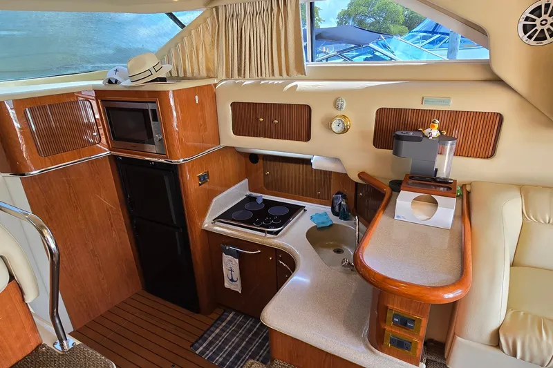 Slide: The Image of Interior of 2000 Sea Ray 400 Sedan Bridge yacht with kitchen amenities. - 26