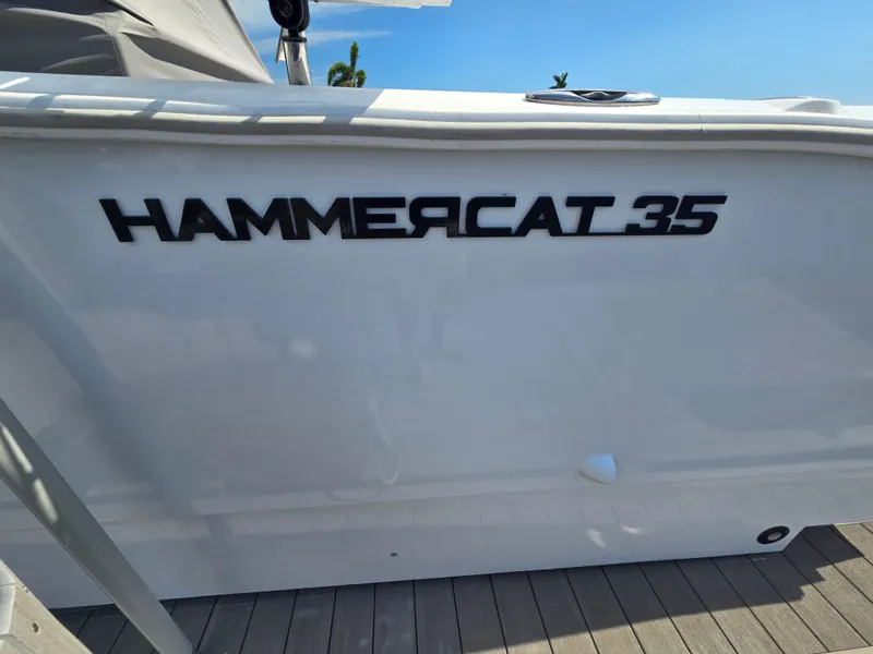 Slide: The Image of The Hammercat 35 is a modern boat with sleek design, docked at a pier. - 16