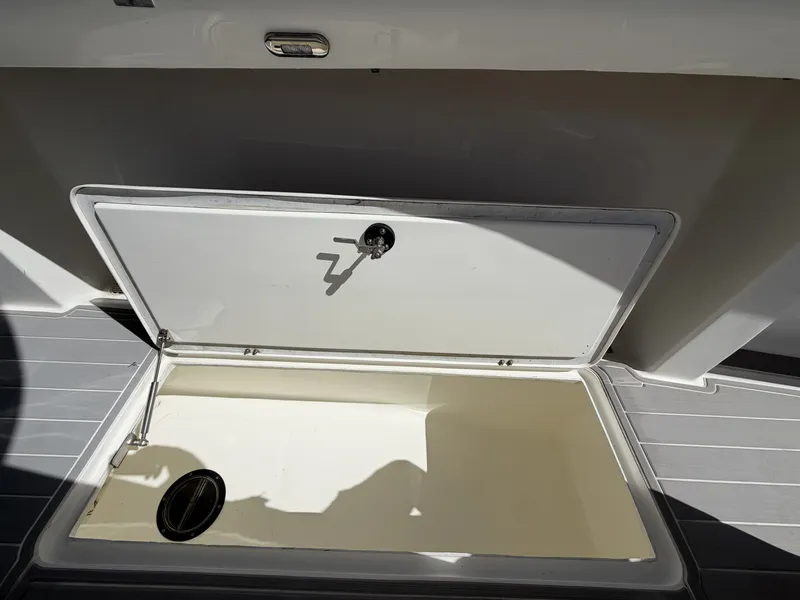 Slide: The Image of An open storage compartment on a 2023 Hammer Yachts 35 Cat, featuring gray flooring. - 25