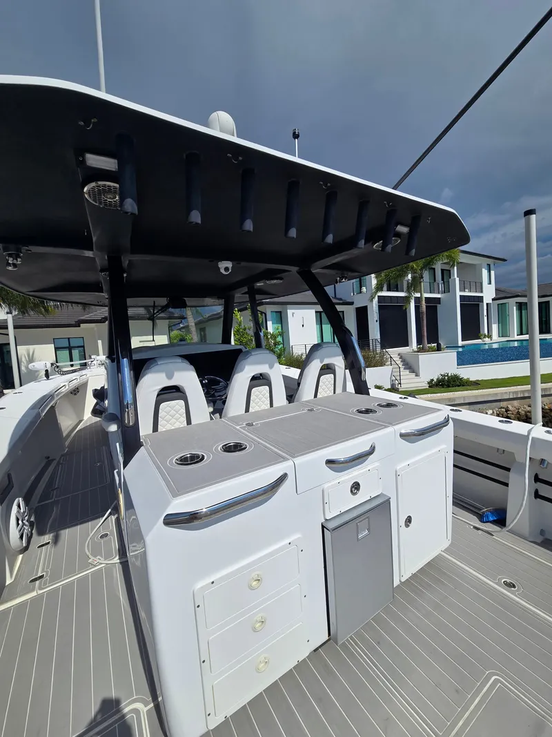 Slide: The Image of The image shows the deck of a 2023 Hammer Yachts 35 Cat with modern seating and storage. - 5