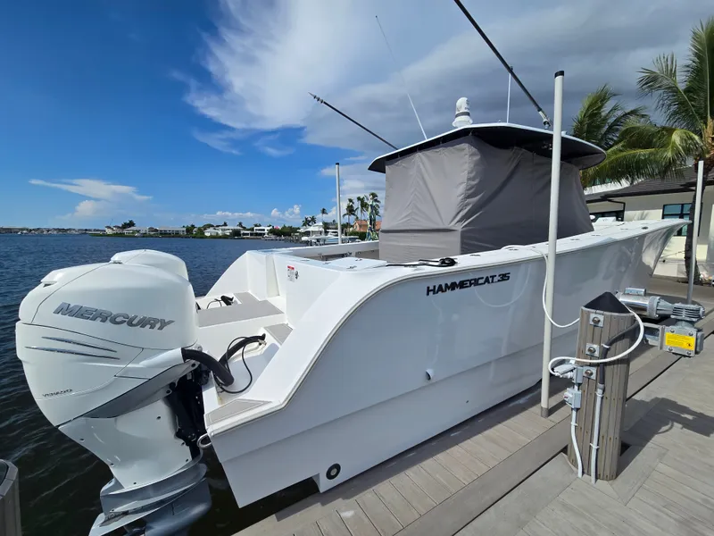 Slide: The Image of A modern 2023 Hammer Yachts 35 Cat docked, featuring a Mercury outboard motor. - 23