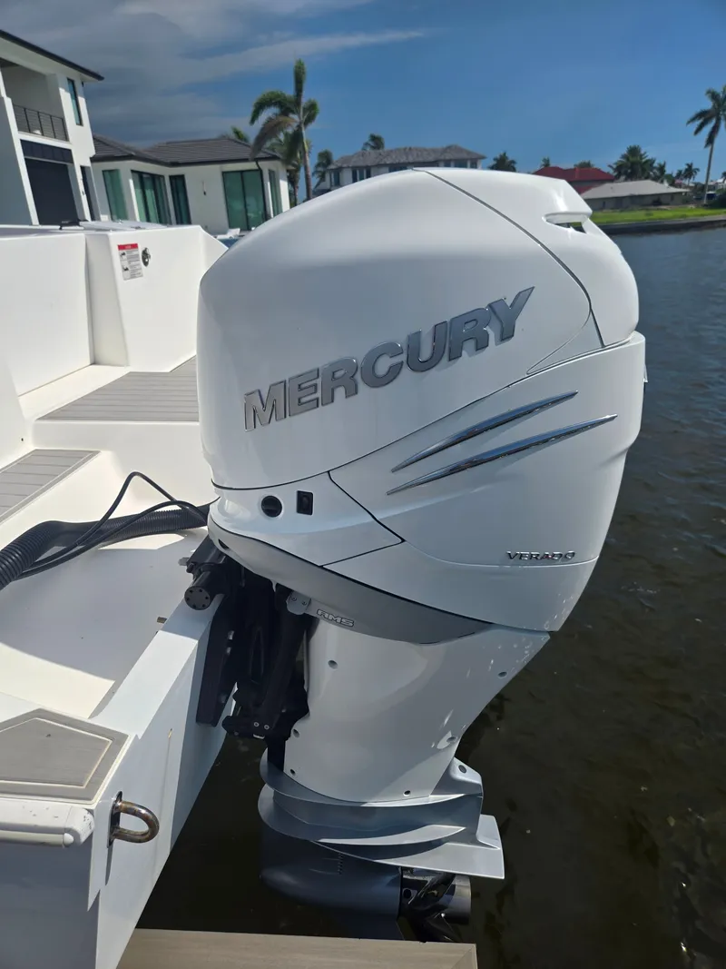 Slide: The Image of A Mercury outboard motor is attached to a 2023 Hammer Yachts 35 Cat, docked by the water. - 3