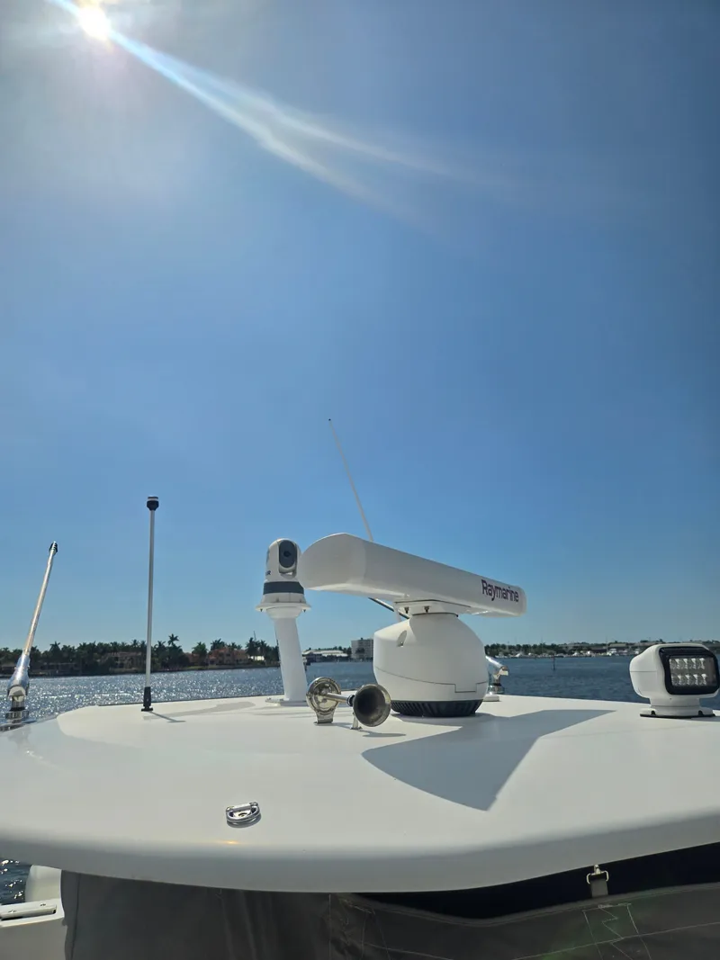 Slide: The Image of Hammer Yachts 35 Cat 2023 with radar equipment on the roof, under a clear sky. - 13