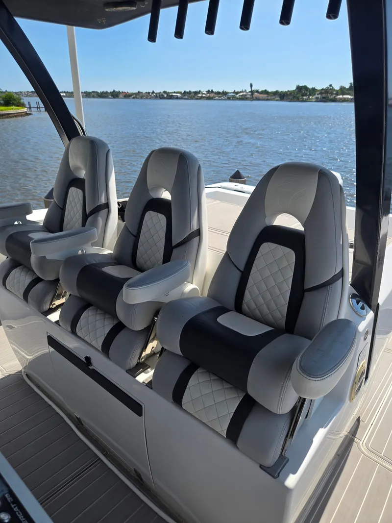 Slide: The Image of Three luxurious seats with armrests on a modern boat, overlooking calm water. - 19