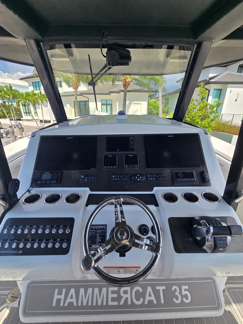 Slide: The Image of The cockpit of the 2023 Hammer Yachts 35 Cat features a modern helm with multiple instruments. - 2