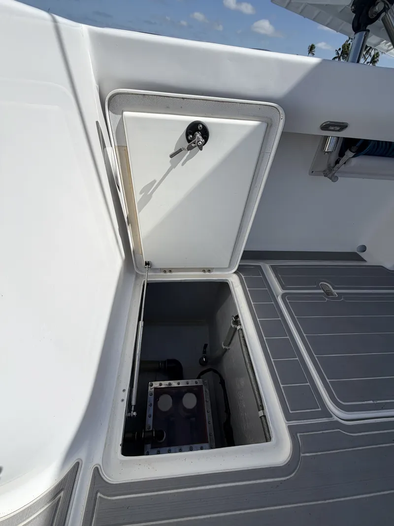 Slide: The Image of An open storage compartment on a 2023 Hammer Yachts 35 Cat, featuring gray flooring. - 26