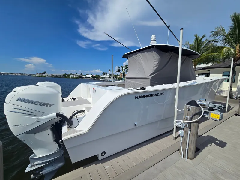 Slide: The Image of A 2023 Hammer Yachts 35 Cat is docked. It features a Mercury engine. - 1