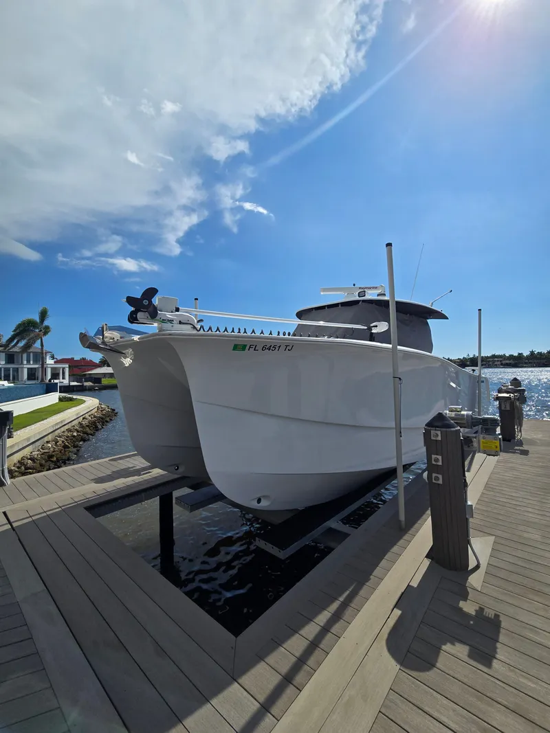 Slide: The Image of A modern catamaran by Hammer Yachts, model 35 Cat, docked under a sunny sky. - 17