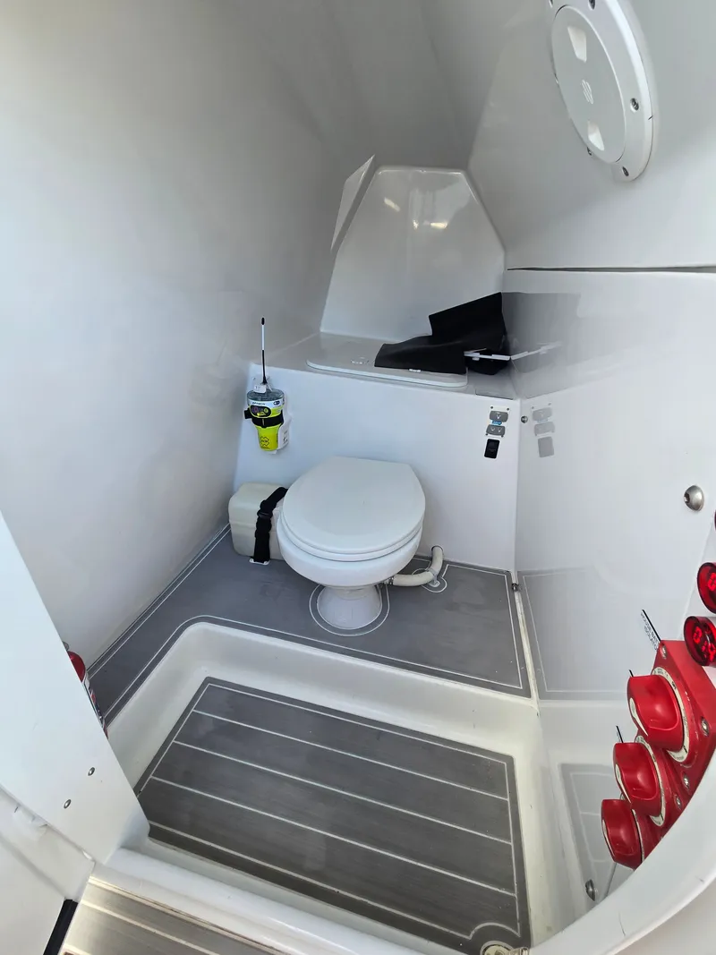 Slide: The Image of The image shows the bathroom of a 2023 Hammer Yachts 35 Cat, featuring a toilet and modern fixtures. - 21