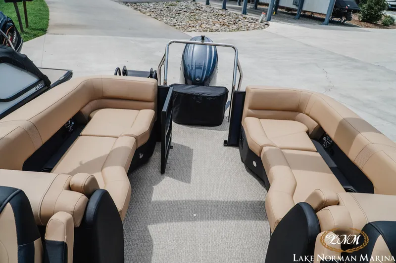 Slide: The Image of Luxurious 2027 Evotti 523QL pontoon boat with spacious tan seating at Lake Norman Marina. - 18