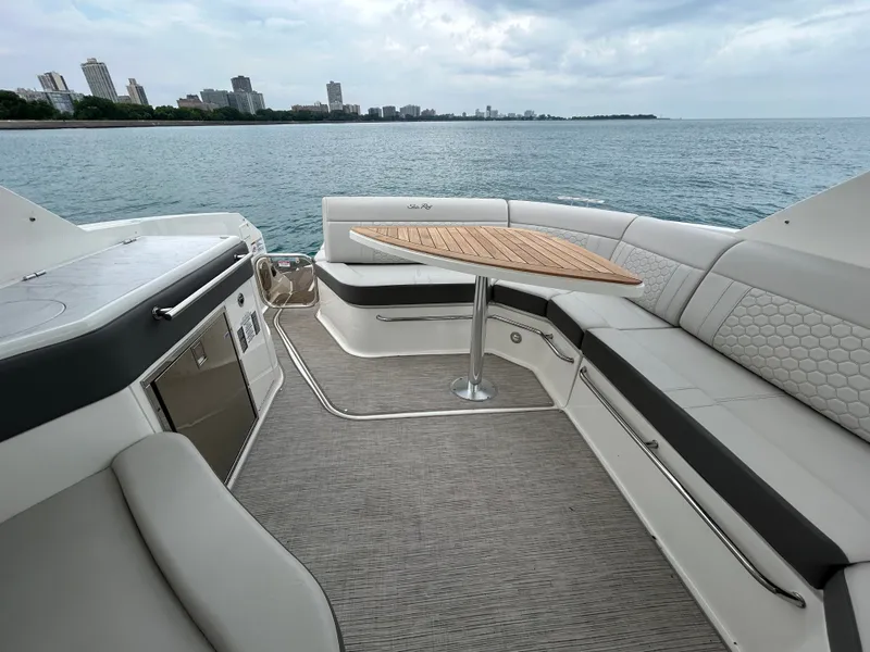 Slide: The Image of The image shows the aft of a Sea Ray Sundancer 320 with elegant seating and a wooden table. - 13