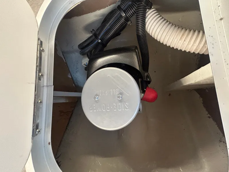 Slide: The Image of A technical compartment with a pump and hoses inside a boat. - 24