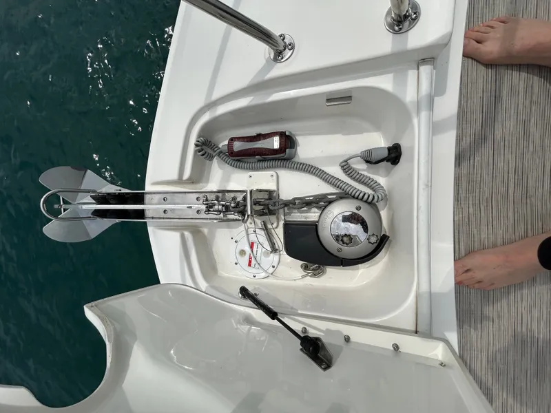 Slide: The Image of Anchor windlass on a boat with rope and controls, surrounded by water. - 21