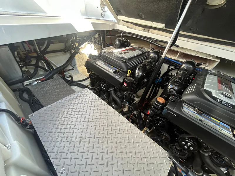 Slide: The Image of The engine room of a 2023 Sea Ray Sundancer 320 features two powerful engines. - 22