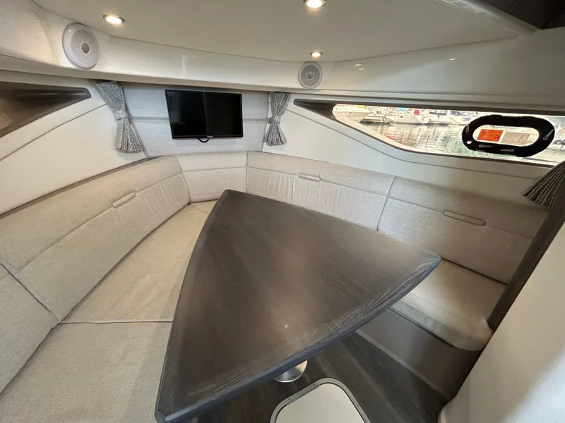 Slide: The Image of Interior of the Sea Ray Sundancer 320 with elegant seating area and table. - 17