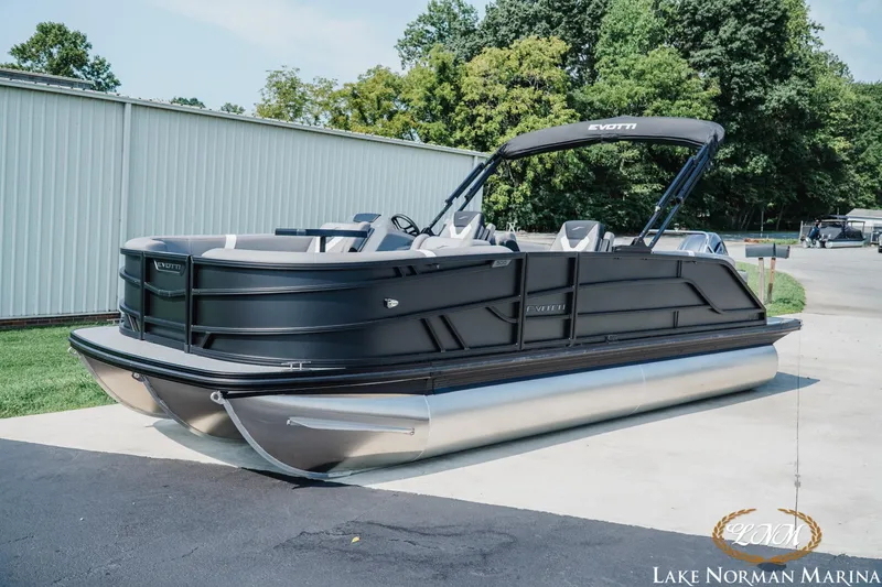 Slide: The Image of 2027 Evotti 521QL pontoon boat at Lake Norman Marina, featuring sleek black design. - 2