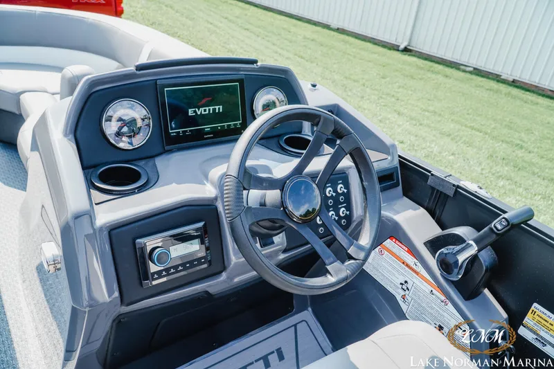 Slide: The Image of Cockpit of 2027 Evotti 521QL boat with steering wheel and control panel at Lake Norman Marina. - 11
