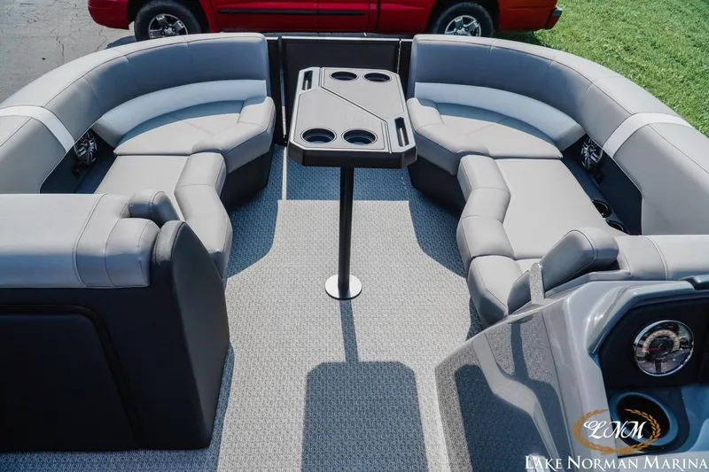 Slide: The Image of Luxurious seating area on 2027 Evotti 521QL pontoon boat with table and cup holders. - 12