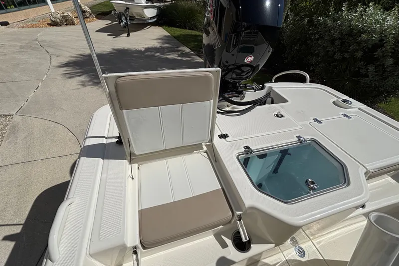 Slide: The Image of 2026 Mako Pro Skiff 19 CC boat interior with seating and storage compartments. - 13