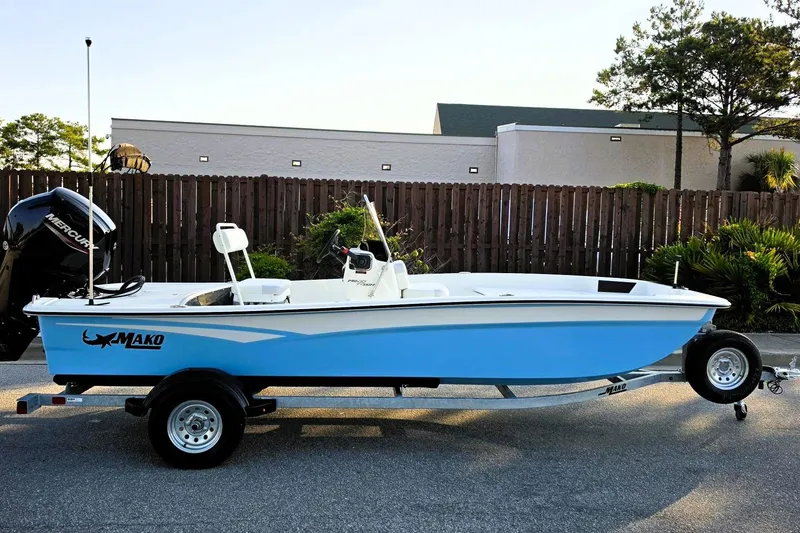 The Image of 2027 Mako Pro Skiff 17 CC boat on trailer, blue hull, outdoor setting. - 0