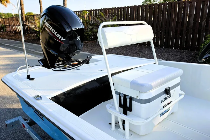 Slide: The Image of 2027 Mako Pro Skiff 17 CC boat with Mercury engine and Igloo cooler on deck. - 13