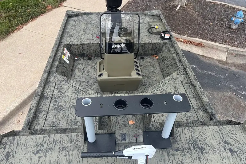 Slide: The Image of 2027 Tracker Grizzly 2072 CC Sportsman boat interior with console and seating. - 17