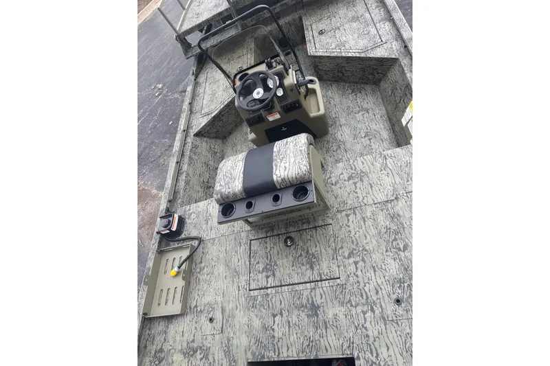 Slide: The Image of 2027 Tracker Grizzly 2072 CC Sportsman boat interior with camouflage design and steering console. - 19