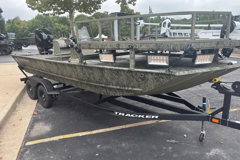 The Image of 2027 Tracker Grizzly 2072 CC Sportsman boat on trailer, parked outdoors. - 0