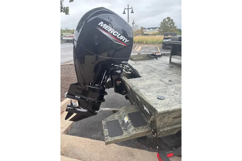 Slide: The Image of 2027 Tracker Grizzly 2072 CC Sportsman with Mercury outboard motor in parking lot. - 22