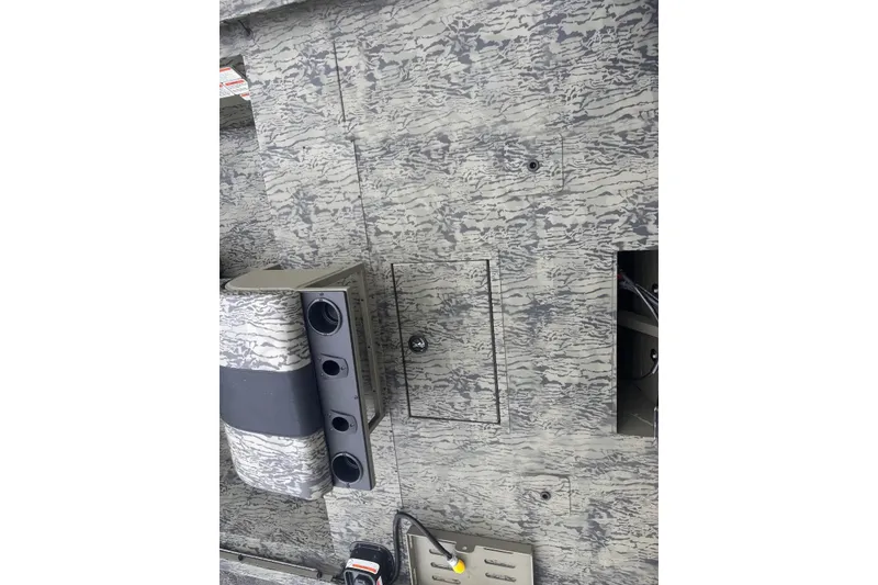 Slide: The Image of Interior view of 2027 Tracker Grizzly 2072 CC Sportsman boat with camo pattern. - 21