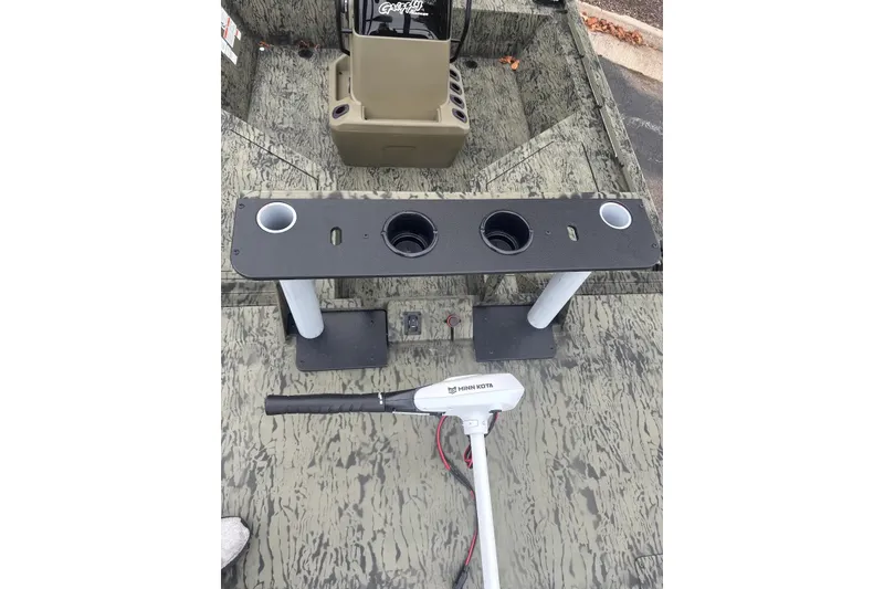 Slide: The Image of 2027 Tracker Grizzly 2072 CC Sportsman boat interior with Minn Kota trolling motor. - 16