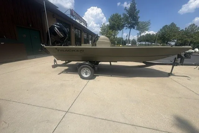 The Image of 2027 Tracker Grizzly 1648 SC boat on trailer, parked outdoors under clear sky. - 0