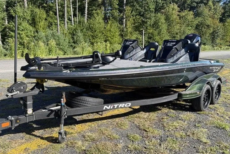 The Image of 2027 Nitro Z18 XL boat on trailer in wooded area. - 0