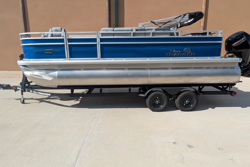 The Image of 2027 Sun Tracker SportFish 20 DLX pontoon boat on trailer, side view. - 0