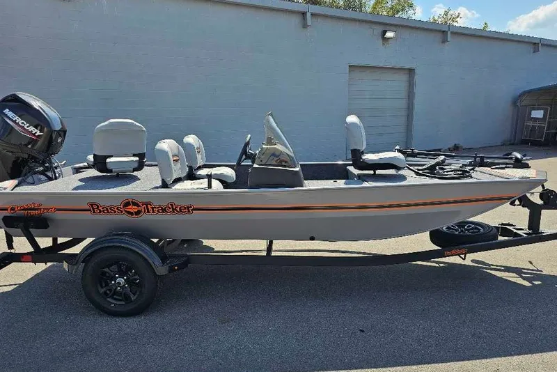 The Image of 2027 Tracker Bass Tracker Classic Limited fishing boat on trailer, parked outdoors. - 0