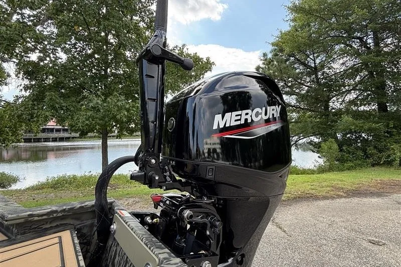 Slide: The Image of Mercury outboard motor on 2027 Tracker Grizzly 1650 T Prairie Wings Edition by a lake. - 13