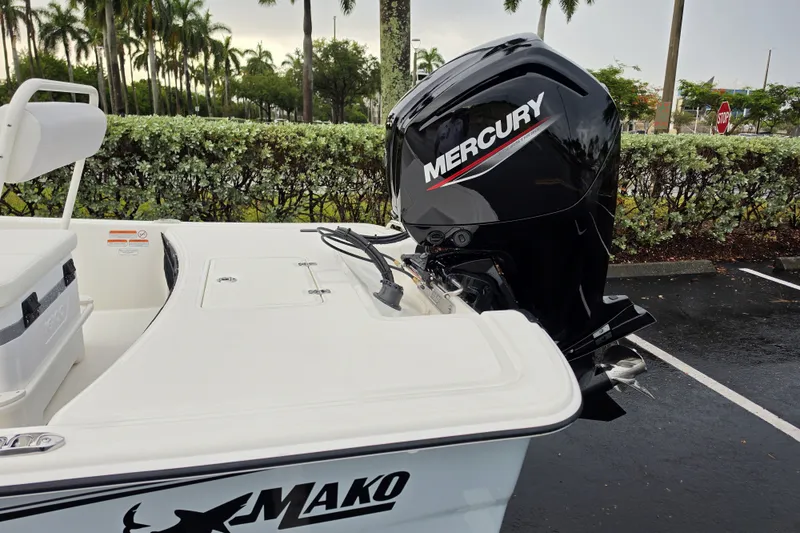 Slide: The Image of 2027 Mako Pro Skiff 17 CC with Mercury outboard motor in a parking lot. - 10