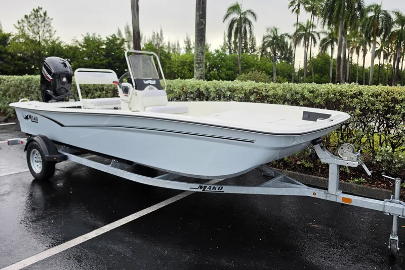 Slide: The Image of 2027 Mako Pro Skiff 17 CC boat on trailer in parking lot. - 2