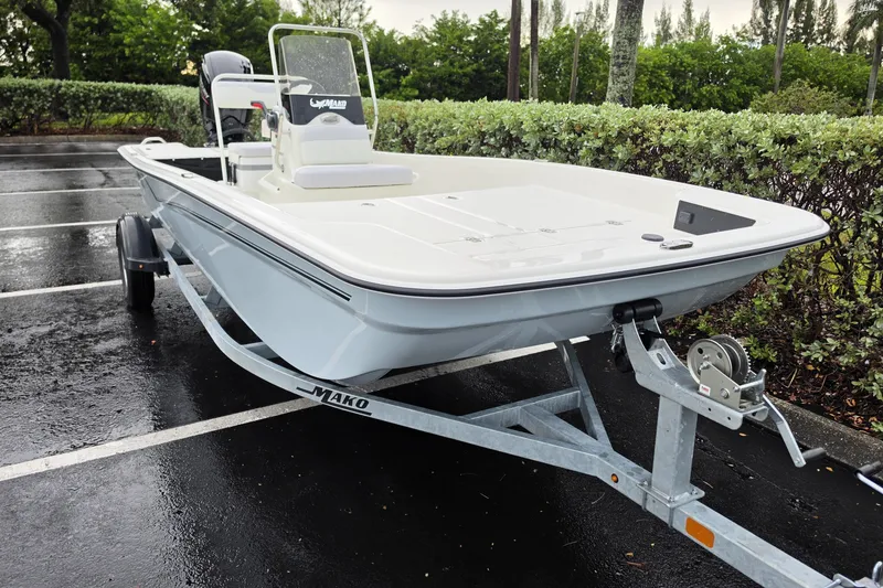 Slide: The Image of 2027 Mako Pro Skiff 17 CC boat on trailer in parking lot. - 3
