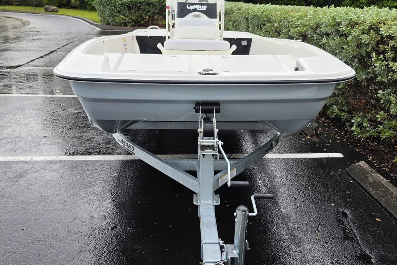 Slide: The Image of 2027 Mako Pro Skiff 17 CC boat on trailer in parking lot. - 4