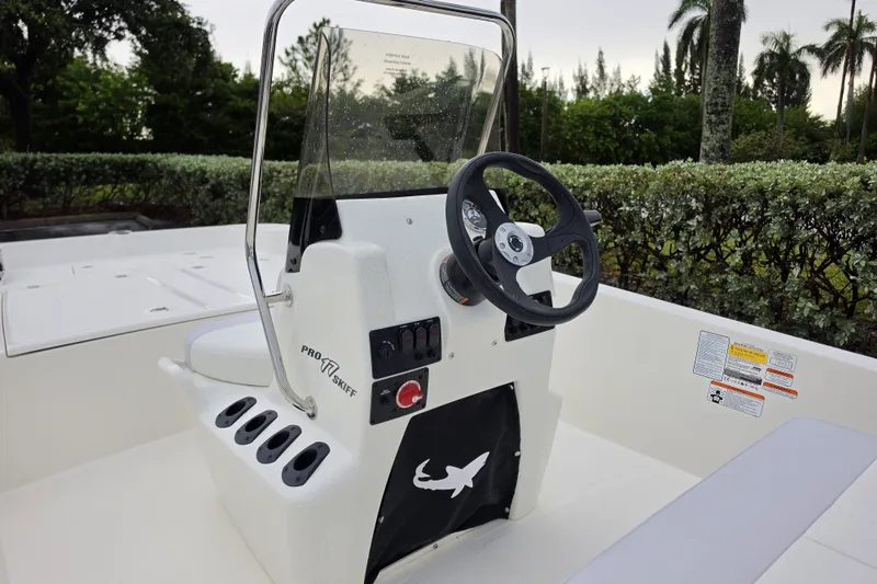 Slide: The Image of 2027 Mako Pro Skiff 17 CC boat console with steering wheel and control panel. - 8
