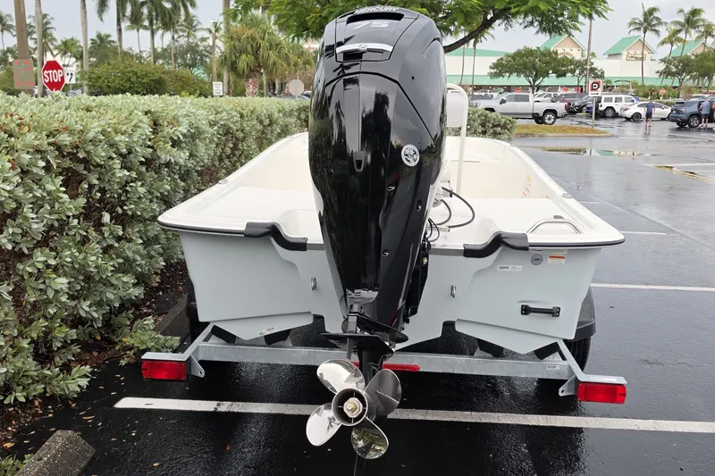 Slide: The Image of 2027 Mako Pro Skiff 17 CC boat on trailer, parked in a lot. - 11