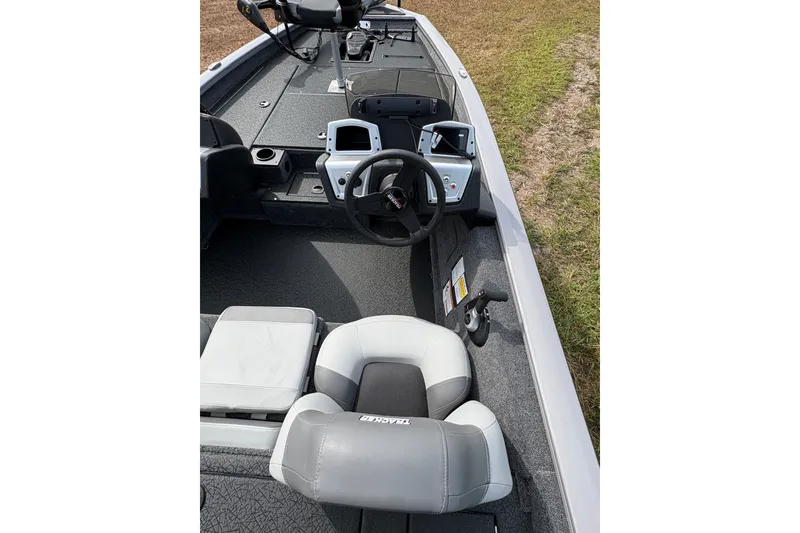 Slide: The Image of Interior view of 2027 Tracker Pro Team 175 boat, featuring steering wheel and seating. - 15