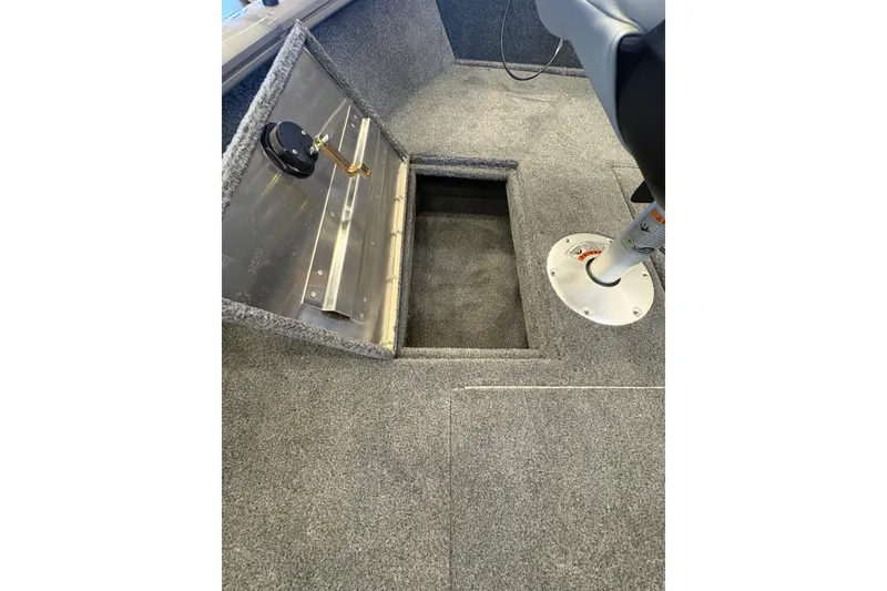 Slide: The Image of Interior of 2027 Tracker Super Guide V-16 SC boat with open storage compartment. - 13