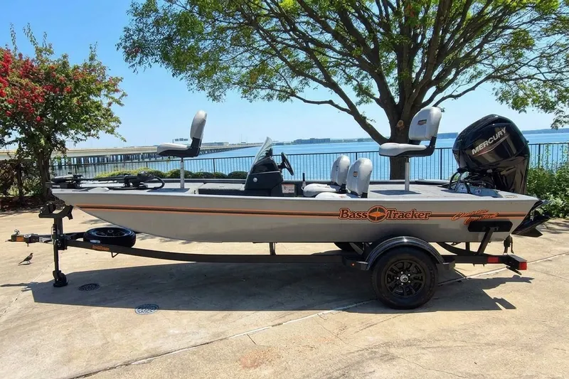 The Image of 2027 Tracker Bass Tracker Classic Limited boat on trailer by lakeside. - 0