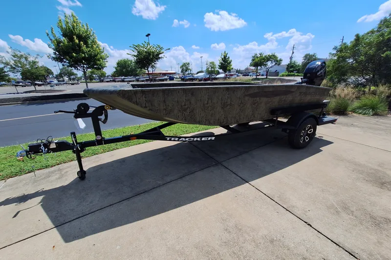 The Image of 2027 Tracker Grizzly 1654 T Sportsman boat on trailer, parked outdoors. - 0