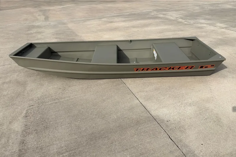 The Image of 2027 Tracker Grizzly 12 Jon boat on concrete surface, showcasing sleek design and durability. - 0