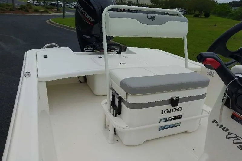 Slide: The Image of 2027 Mako Pro Skiff 17 CC boat interior with Igloo cooler and Mercury engine. - 3