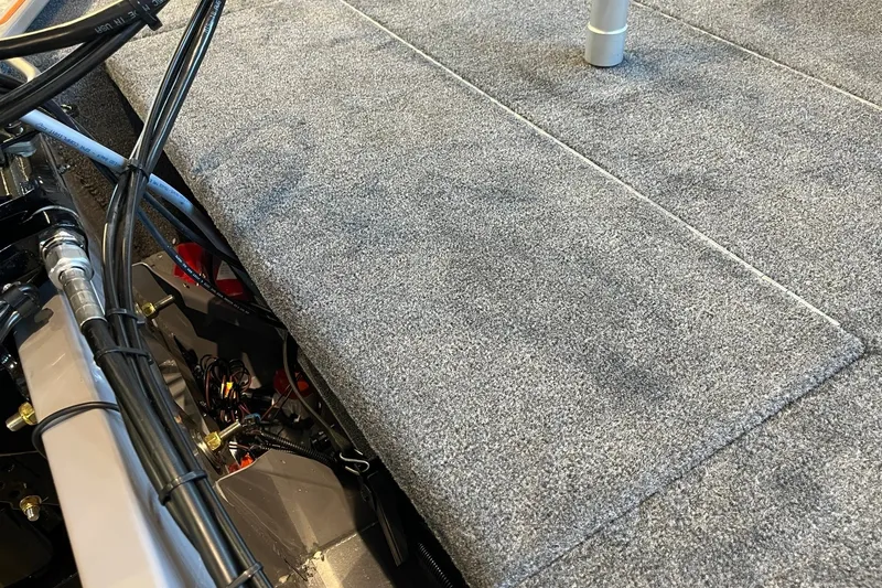 Slide: The Image of 2027 Tracker Bass Tracker Classic Limited boat interior with gray carpet and visible wiring. - 24